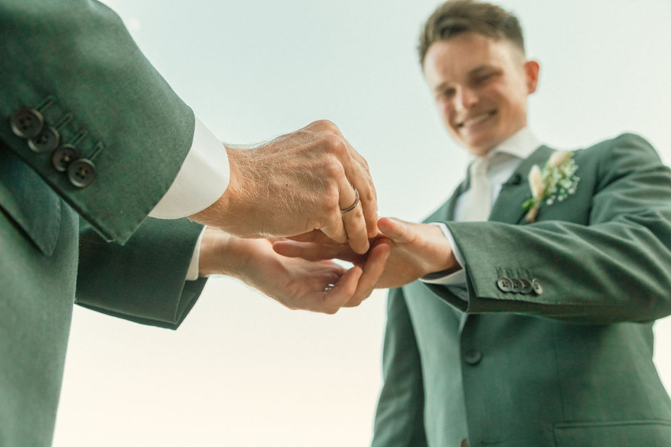 Two people exchanging rings at a wedding ceremony in Skiathos.