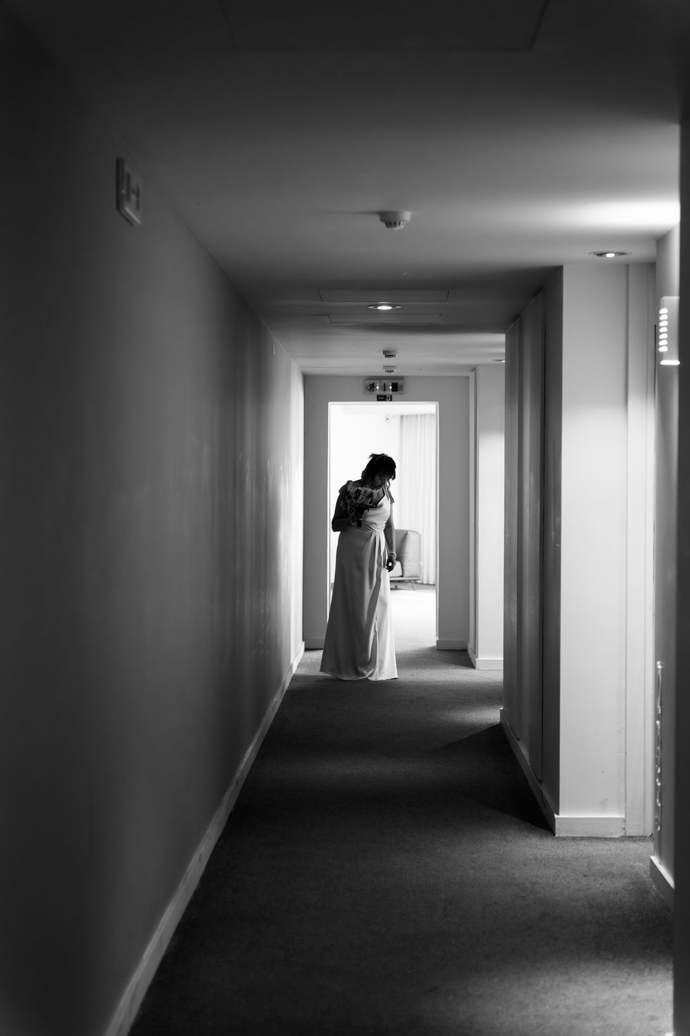 Bride standing in a dimly lit hallway in Skiathos.