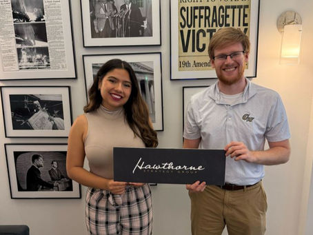 Tyler and Denise pose with the Hawthorne sign