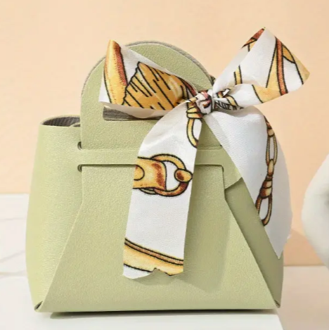 Thumbnail: Faux Leather Favour Bags double up as place settings 