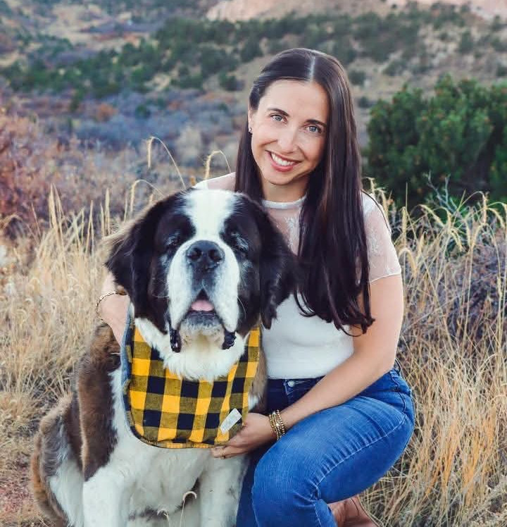 Woman with a Saint Bernard at Purple Lotus Counseling.