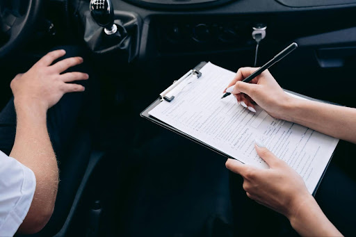 Insurance consultant reviewing client assessment paperwork during a risk evaluation meeting.