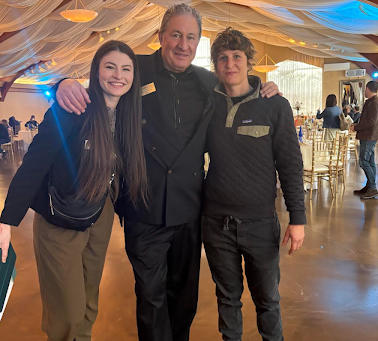 Event staff and guests at Stable Gate Winery's rustic-chic indoor ballroom, showcasing the venue's unique ceiling drapery and spacious floor for weddings and private parties.