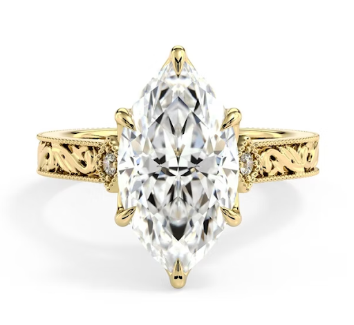 Marquise cut diamond engagement ring with intricate vintage-style filigree band and yellow gold setting.