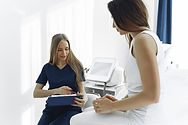 woman-in-blue-scrub-suit-helping-woman-s