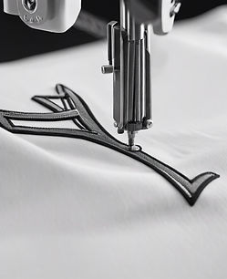 black & white image of an embroidery machine doing a logo on a golf Polo.jpg