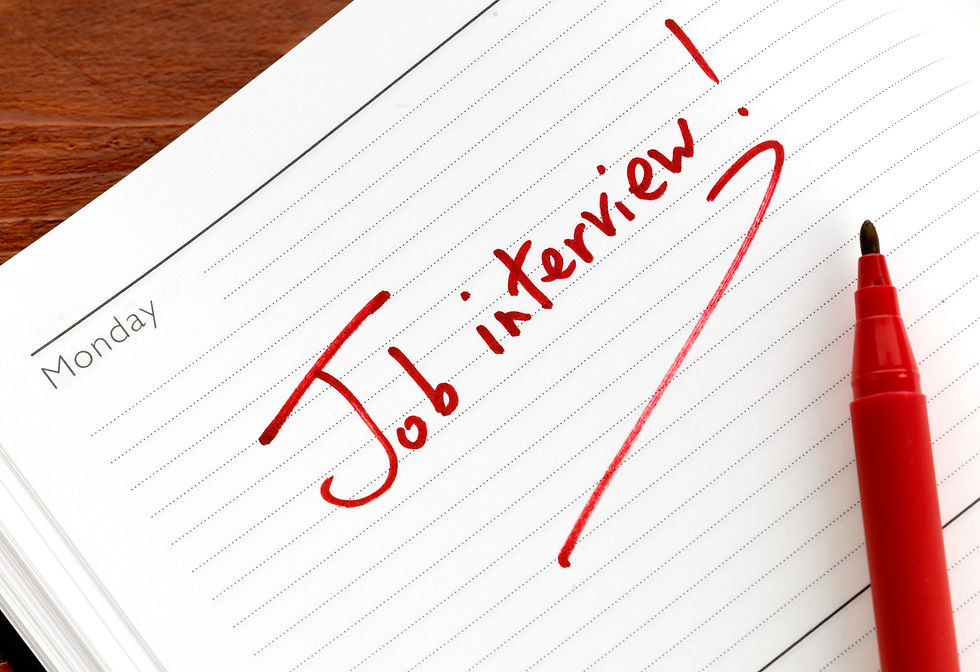 Notebook page with "Job interview!" written in red marker, showing urgency. Day label "Monday" visible. Red marker lies nearby.