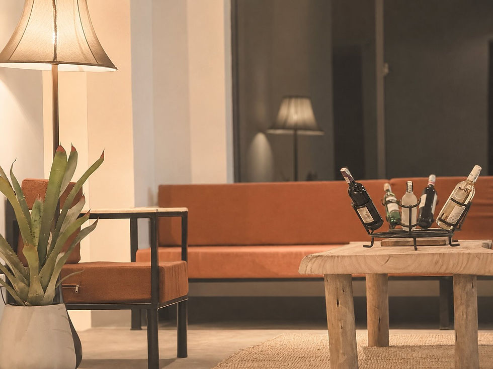Luxury hotel lounge at Aurica Arusha featuring contemporary African design, comfortable seating, artisan wooden furniture and a curated wine display.