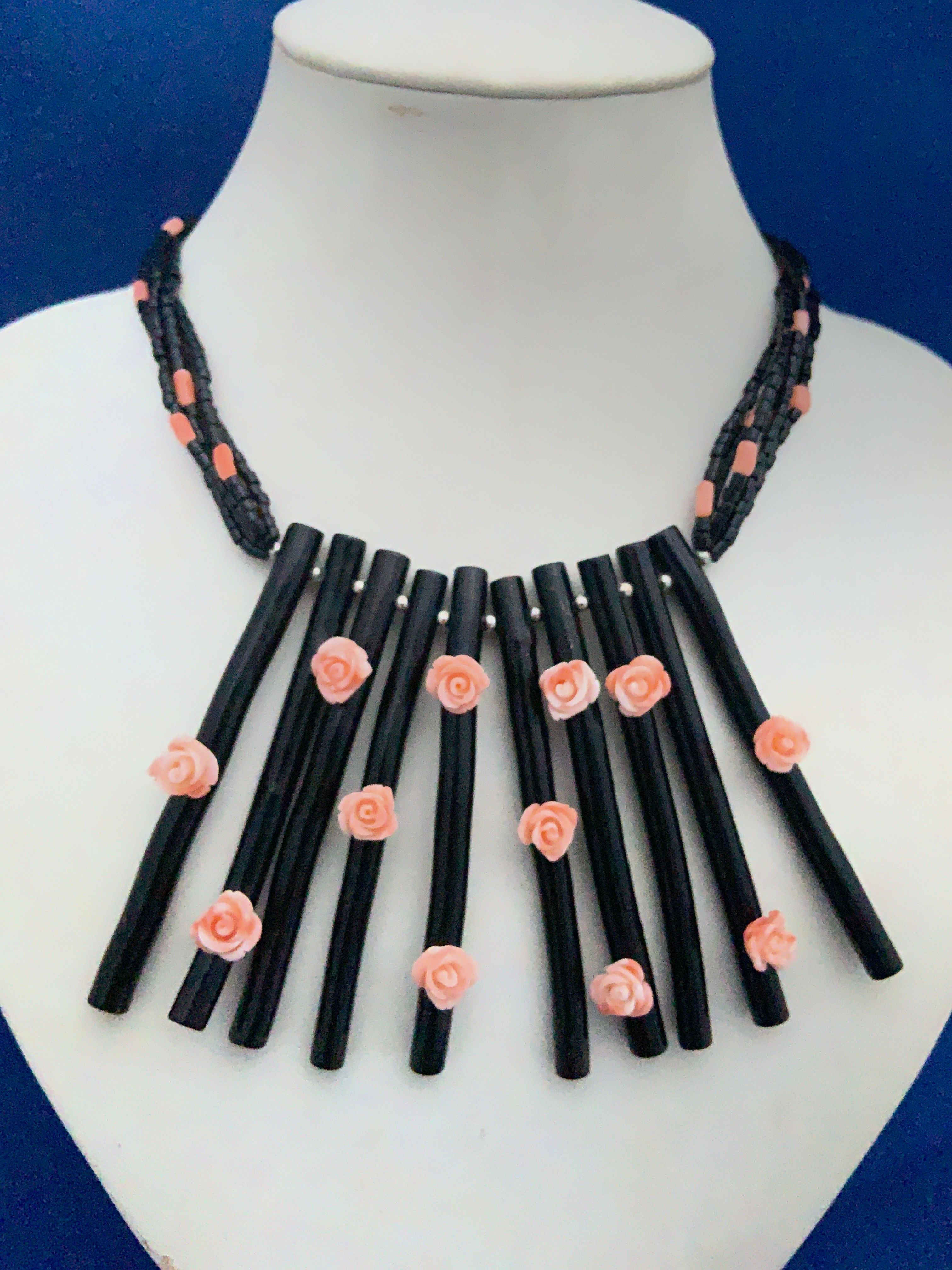 Coral flowers and tubes on dyed coral with sterling silver.