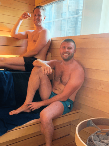 Two male friends enjoying a sauna