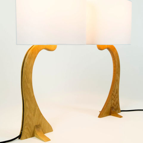 Pair of curved wooden table lamps with white shades as part of hand made nature inspired furniture
