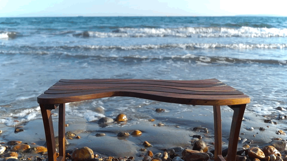 Wavy shape coffee table on a beach with waves 