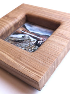 Wooden picture frame with landscape photo