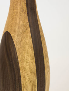 Curved wooden lamp close up with light and dark wood grain as part of hand made nature inspired furniture