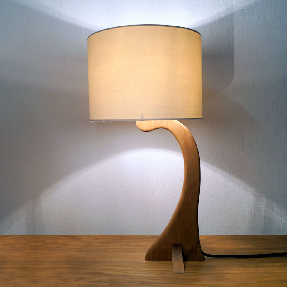 Thumbnail: Modern table lamp with curved wood base and fabric shade