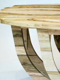 Modern wooden table with curved base as part of hand made nature inspired furniture