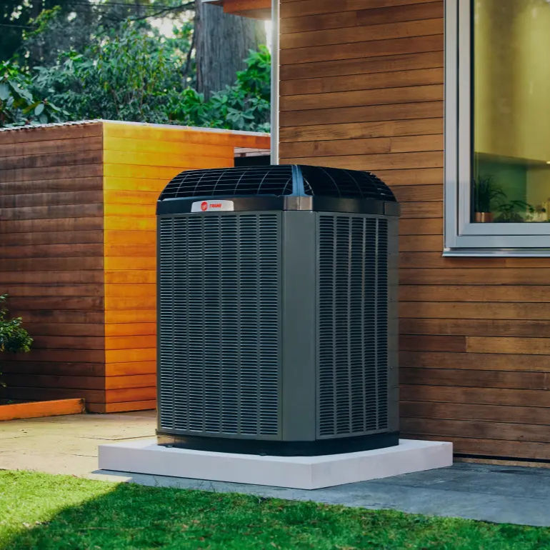 Eye-level view of a residential air conditioner unit outside a Wisconsin home