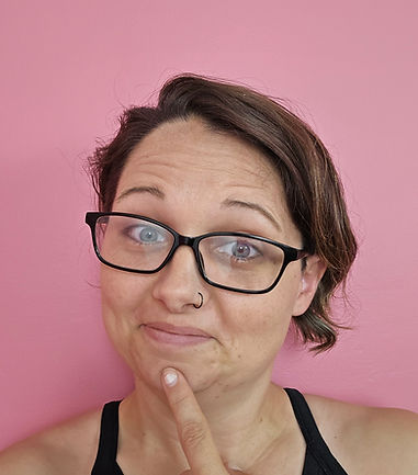 Tara White, in front of a pink wall. 