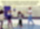 children playing musical instruments in gymnasium