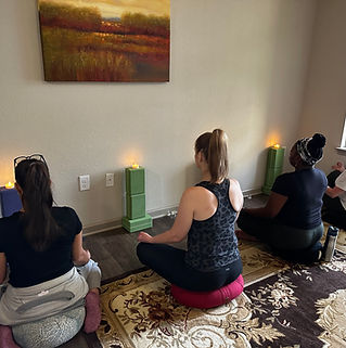 students meditating gazing at candle