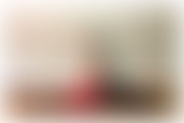 Practicing Reclined Hand to Big Toe position to stretch the hamstrings and calf assisted with a yoga strap for more control through the experience.