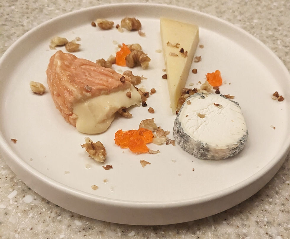 Plate of three wedges of oozing french cheeses at the restaurant Chonbou, Paris