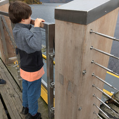 autistic child standing on a pier and taking in the view of Loch Lomond, Luss village, Scotland