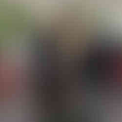 The welcome sign at Arancina, a statue of a man in chef's whites holding a suggestive platter arrangment of tall and round arancini. a gluten free arancini restaurant, perfect for our autistic family.