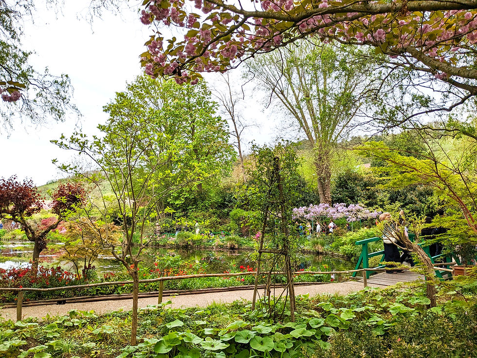 Wide angle landscape view of Claude Monet's garden grounds in Giverny showing open sensory friendly spaces for neurodivergent family travel.