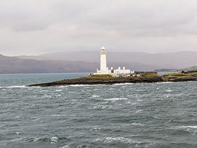 A lighthouse seen from the CalMac ferry travelling between Oban and the Isle of Mull