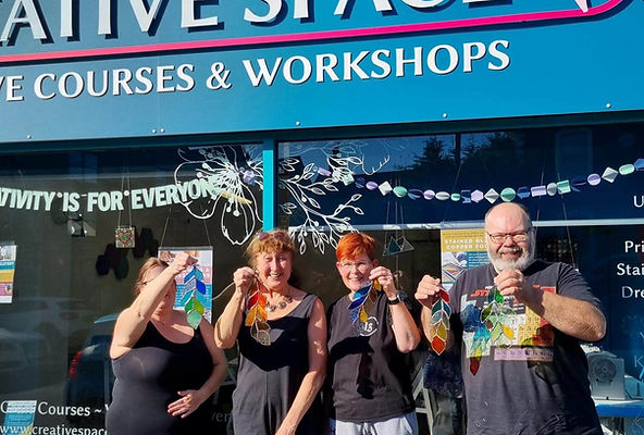 People at Creative space bristol with copper foiled feathers