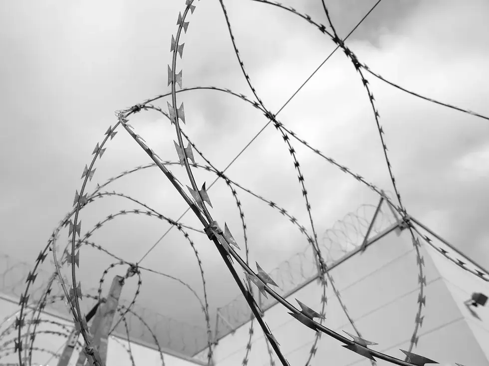 Coiled razor wire against a cloudy sky