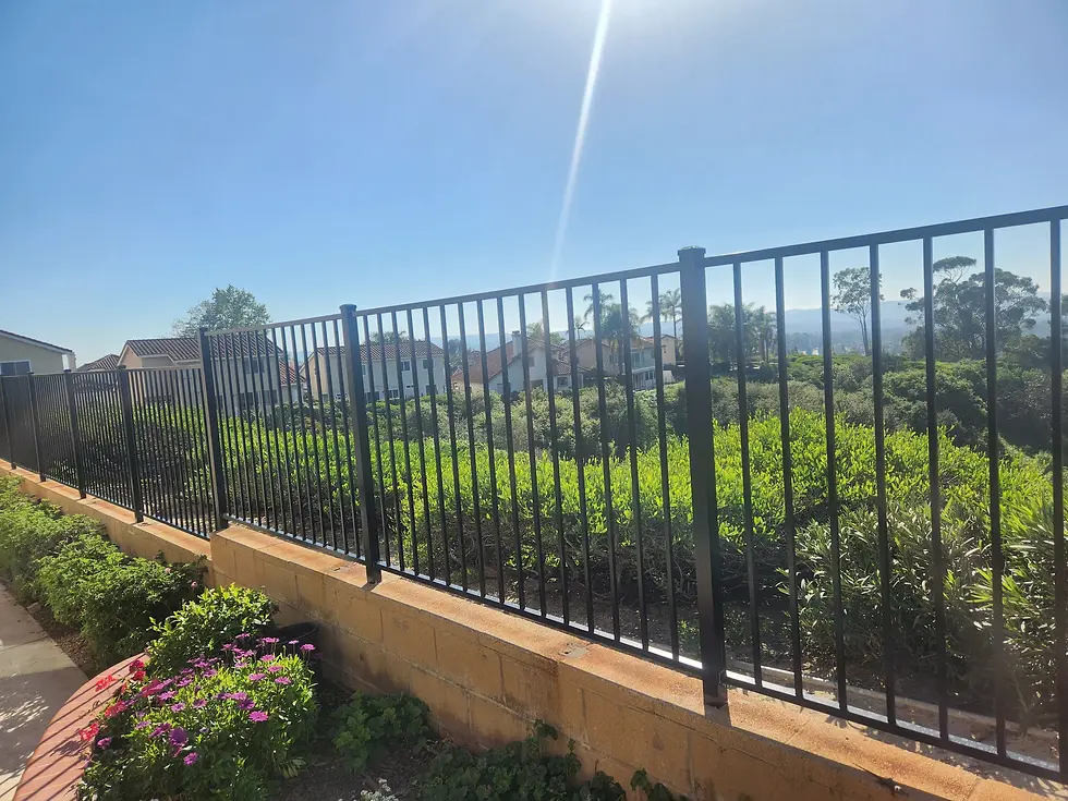 Aluminum 2 rail fence installed on top of a cmu wall.
