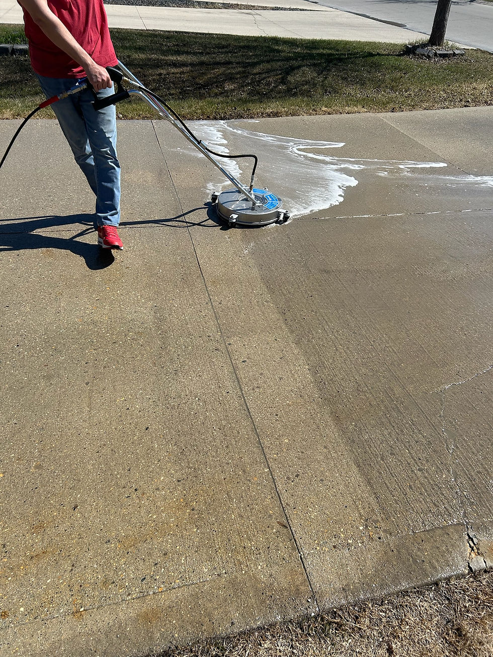 Winnipeg Pro Wash cleaning a concrete driveway with a rotary surface cleaner