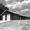 Post frame building pole barn with two roll-up doors, concrete floor, metal siding and roo