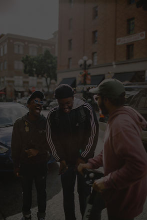 three men in jacket laughing at each oth