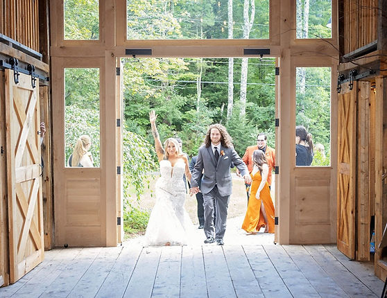 Bride and groom entering wedding reception at rustic venue catered by Tastyplates in and around Boston