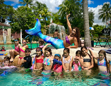 Mermaid party character swimming with child at pool party in Miami