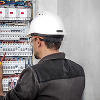 man-electrical-technician-working-switchboard-with-fuses-installation-connection-electrica