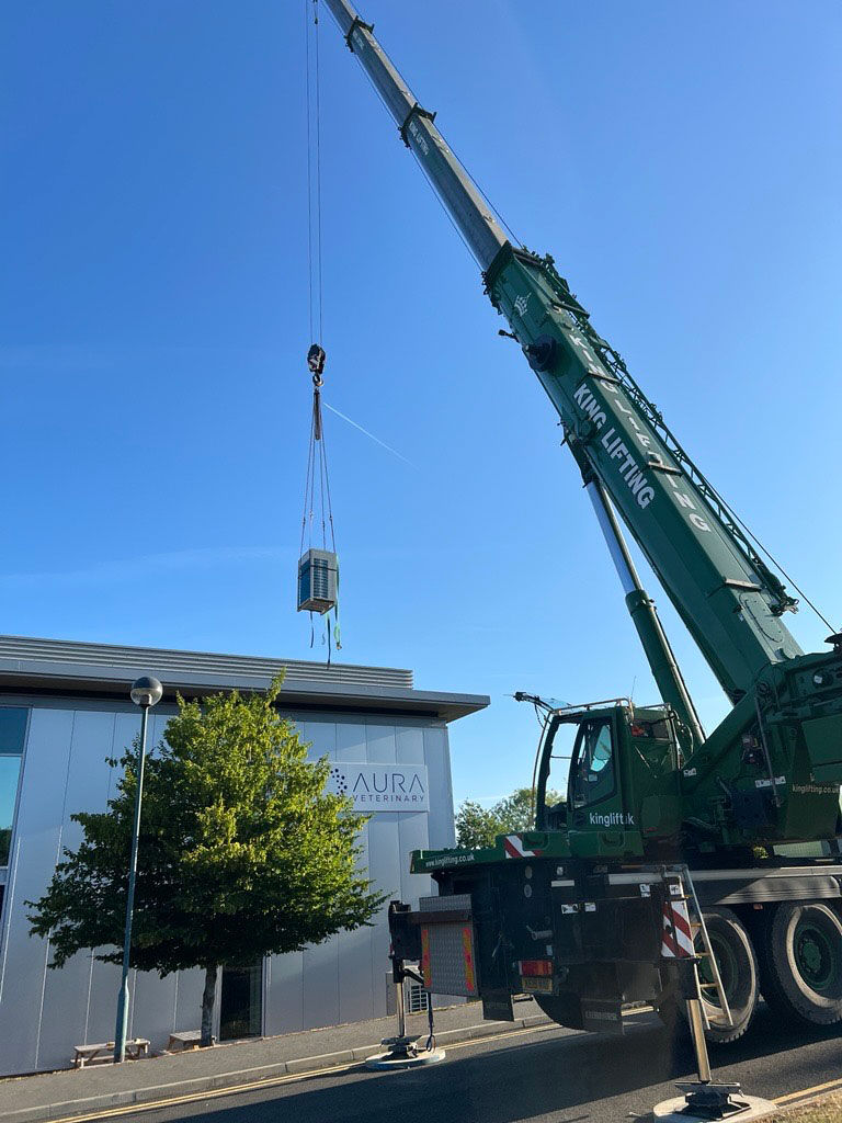 Crane lifting air conditioning unit