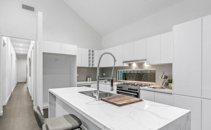 Contemporary Kitchen With Stone Island Bench and Pendant Lighting