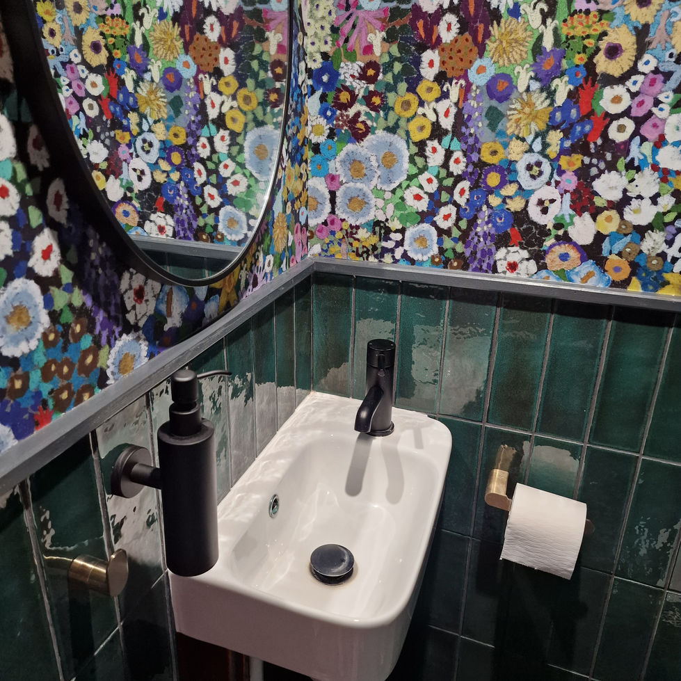 a bathroom with a floral wallpaper and a sink