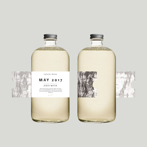 May-mahlajuomapullo, jossa koivunkaarna etiketti ja hopeanvärinen kierrekorkki.