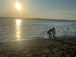 Two Kids playing on the beach at sunset