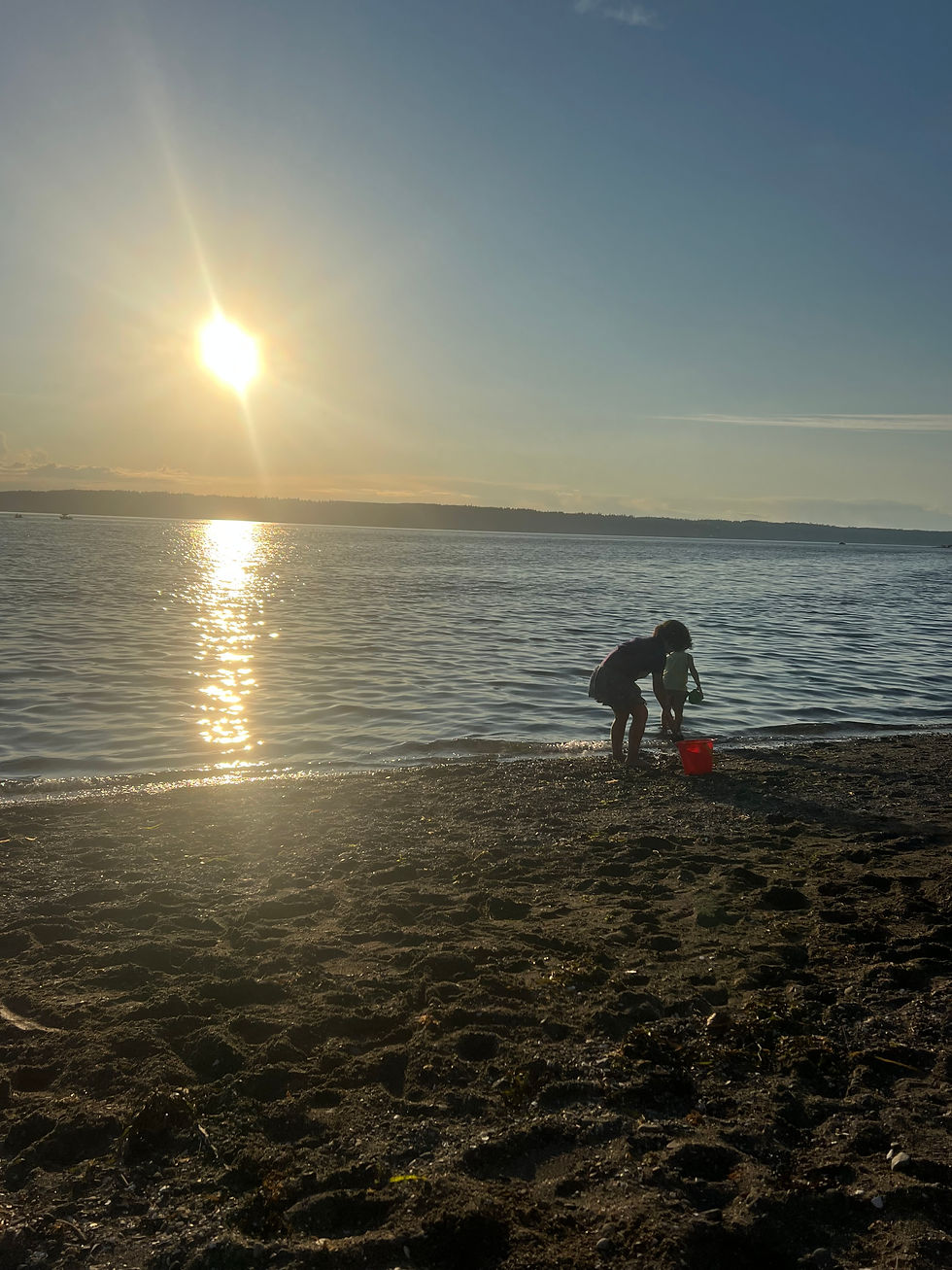 Two Kids playing on the beach at sunset