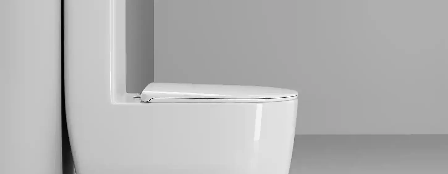 Side profile shot of the one-piece toilet leaning against a plain bathroom wall. Slim wall-hugging shape eliminates hard-to-reach cleaning corners. High-temperature glossy ceramic resists mineral stains and salt air from coastal Southeast Asian regions, matching all modern minimalist bathroom styles.