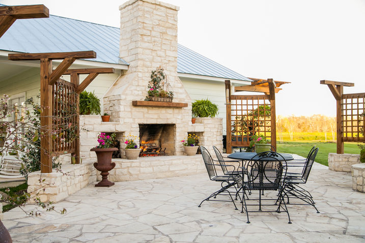 Outdoor living area with limestone fireplace and flagstone patio.