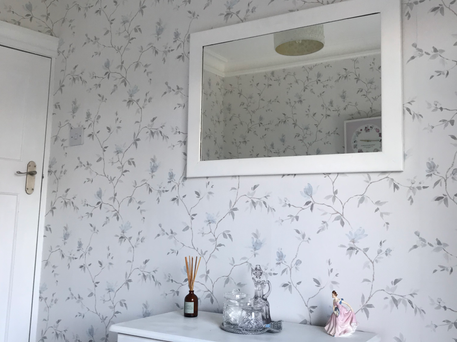 Small bedroom with new floral wallpaper