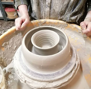 A pottery wheel with a thrown clay doughnut.