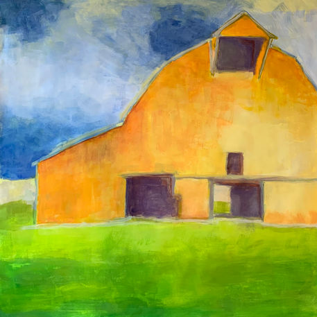 orange-colored barn with grass and blue sky